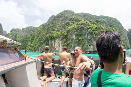 KRABI, THAILAND - April 28, 2017: Holidaymakers relaxing on the beach in Railay Beach. This is a popular tourist destination. Image contain certain grain or noise and soft focus.のeditorial素材