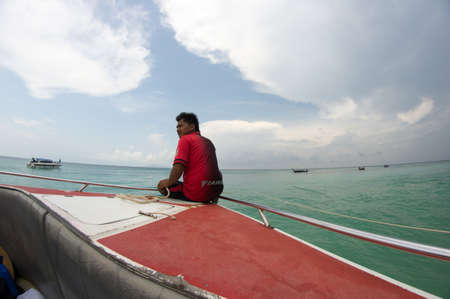 KRABI, THAILAND - April 28, 2017: Holidaymakers relaxing on the beach in Railay Beach. This is a popular tourist destination. Image contain certain grain or noise and soft focus.のeditorial素材