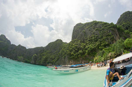 KRABI, THAILAND - April 28, 2017: Holidaymakers relaxing on the beach in Railay Beach. This is a popular tourist destination. Image contain certain grain or noise and soft focus.のeditorial素材