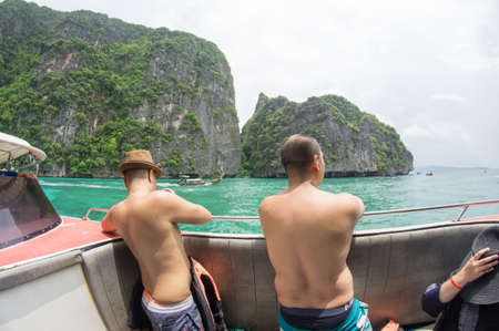 KRABI, THAILAND - April 28, 2017: Holidaymakers relaxing on the beach in Railay Beach. This is a popular tourist destination. Image contain certain grain or noise and soft focus.のeditorial素材