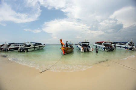KRABI, THAILAND - April 28, 2017: Holidaymakers relaxing on the beach in Railay Beach. This is a popular tourist destination. Image contain certain grain or noise and soft focus.のeditorial素材