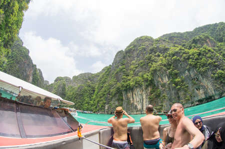 KRABI, THAILAND - April 28, 2017: Holidaymakers relaxing on the beach in Railay Beach. This is a popular tourist destination. Image contain certain grain or noise and soft focus.のeditorial素材