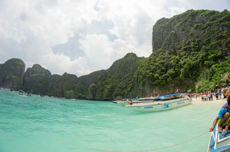 KRABI, THAILAND - April 28, 2017: Holidaymakers relaxing on the beach in Railay Beach. This is a popular tourist destination. Image contain certain grain or noise and soft focus.のeditorial素材