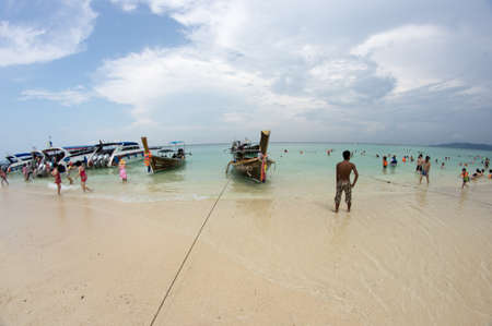 KRABI, THAILAND - April 28, 2017: Holidaymakers relaxing on the beach in Railay Beach. This is a popular tourist destination. Image contain certain grain or noise and soft focus.のeditorial素材