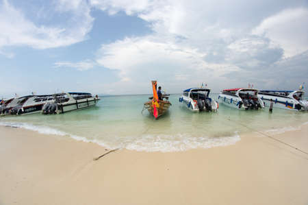 KRABI, THAILAND - April 28, 2017: Holidaymakers relaxing on the beach in Railay Beach. This is a popular tourist destination. Image contain certain grain or noise and soft focus.のeditorial素材