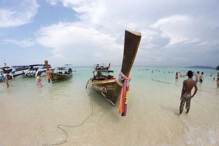 KRABI, THAILAND - April 28, 2017: Holidaymakers relaxing on the beach in Railay Beach. This is a popular tourist destination. Image contain certain grain or noise and soft focus.のeditorial素材