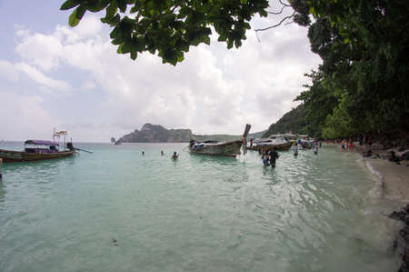KRABI, THAILAND - April 28, 2017: Holidaymakers relaxing on the beach in Railay Beach. This is a popular tourist destination. Image contain certain grain or noise and soft focus.のeditorial素材