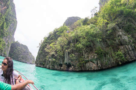 KRABI, THAILAND - April 28, 2017: Holidaymakers relaxing on the beach in Railay Beach. This is a popular tourist destination. Image contain certain grain or noise and soft focus.のeditorial素材