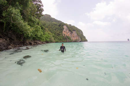 KRABI, THAILAND - April 28, 2017: Holidaymakers relaxing on the beach in Railay Beach. This is a popular tourist destination. Image contain certain grain or noise and soft focus.のeditorial素材