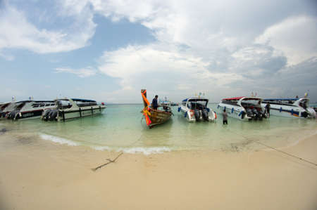 KRABI, THAILAND - April 28, 2017: Holidaymakers relaxing on the beach in Railay Beach. This is a popular tourist destination. Image contain certain grain or noise and soft focus.のeditorial素材