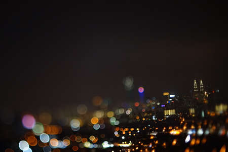 Blurred dramatic night view of city with abstract of LED, neon lights and beautiful bokeh.の写真素材
