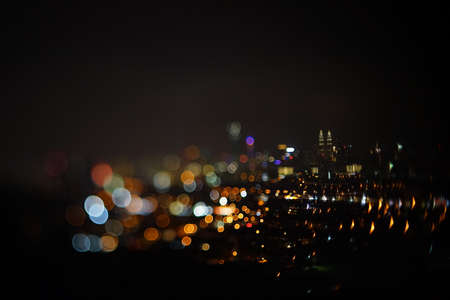 Blurred dramatic night view of city with abstract of LED, neon lights and beautiful bokeh.の写真素材