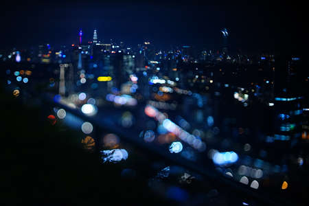 Blurred dramatic night view of city with abstract of LED, neon lights and beautiful bokeh.の写真素材