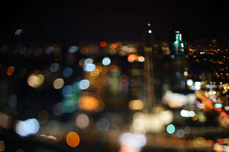 Blurred dramatic night view of city with abstract of LED, neon lights and beautiful bokeh.