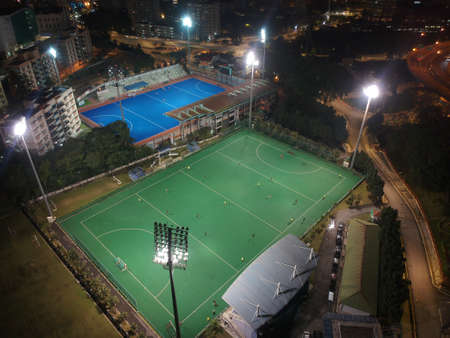 Aerial view of outdoor hockey field during night. The image contains soft focus, grain and noise.の写真素材