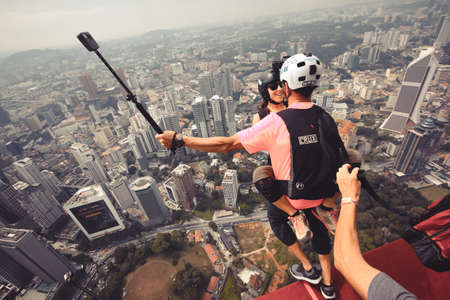 Kuala Lumpur, Malaysia â€“ September 28, 2018: Base Jumpers jump from a 300m high deck during...