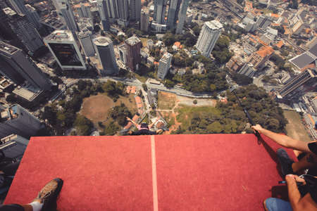 Kuala Lumpur, Malaysia â September 28, 2018: Base Jumpers jump from a 300m high deck during the Kuala Lumpur Tower International Jump.のeditorial素材