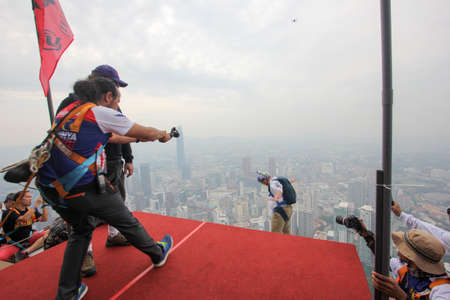 Kuala Lumpur, Malaysia â€“ September 29, 2018: Base Jumpers jump from a 300m high deck during...