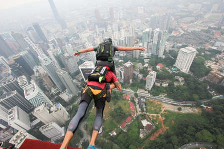 Kuala Lumpur, Malaysia â September 29, 2018: Base Jumpers jump from a 300m high deck during the Kuala Lumpur Tower International Jump.のeditorial素材