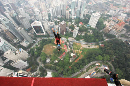 Kuala Lumpur, Malaysia â September 29, 2018: Base Jumpers jump from a 300m high deck during the Kuala Lumpur Tower International Jump.のeditorial素材