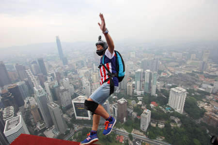 Kuala Lumpur, Malaysia â September 29, 2018: Base Jumpers jump from a 300m high deck during the Kuala Lumpur Tower International Jump.のeditorial素材