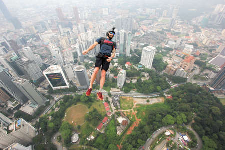 Kuala Lumpur, Malaysia â September 29, 2018: Base Jumpers jump from a 300m high deck during the Kuala Lumpur Tower International Jump.のeditorial素材