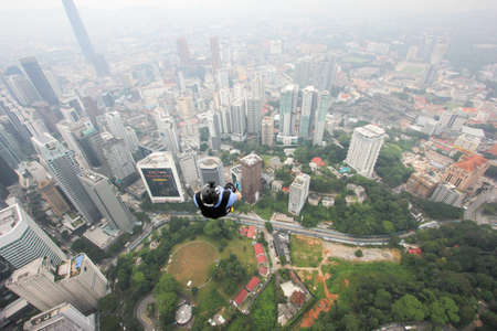 Kuala Lumpur, Malaysia â September 29, 2018: Base Jumpers jump from a 300m high deck during the Kuala Lumpur Tower International Jump.のeditorial素材