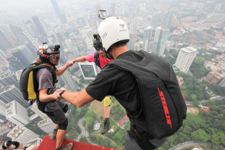 Kuala Lumpur, Malaysia â€“ September 29, 2018: Base Jumpers jump from a 300m high deck during...