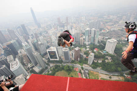 Kuala Lumpur, Malaysia â€“ September 29, 2018: Base Jumpers jump from a 300m high deck during...