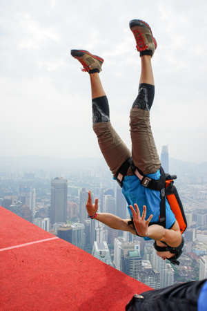 Kuala Lumpur, Malaysia â€“ September 29, 2018: Base Jumpers jump from a 300m high deck during...
