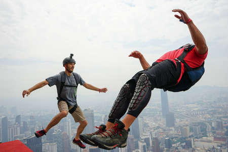 Kuala Lumpur, Malaysia â September 29, 2018: Base Jumpers jump from a 300m high deck during the Kuala Lumpur Tower International Jump.のeditorial素材