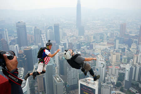 Kuala Lumpur, Malaysia â September 29, 2018: Base Jumpers jump from a 300m high deck during the Kuala Lumpur Tower International Jump.のeditorial素材