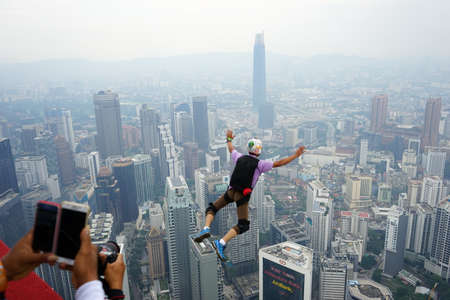 Kuala Lumpur, Malaysia â September 29, 2018: Base Jumpers jump from a 300m high deck during the Kuala Lumpur Tower International Jump.のeditorial素材