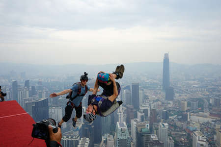 Kuala Lumpur, Malaysia â September 29, 2018: Base Jumpers jump from a 300m high deck during the Kuala Lumpur Tower International Jump.のeditorial素材