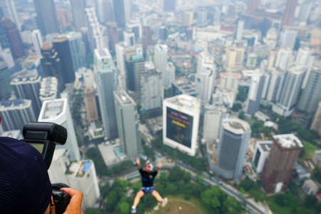 Kuala Lumpur, Malaysia â September 29, 2018: Base Jumpers jump from a 300m high deck during the Kuala Lumpur Tower International Jump.のeditorial素材