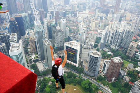 Kuala Lumpur, Malaysia â September 29, 2018: Base Jumpers jump from a 300m high deck during the Kuala Lumpur Tower International Jump.のeditorial素材