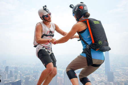 Kuala Lumpur, Malaysia â€“ September 29, 2018: Base Jumpers jump from a 300m high deck during...