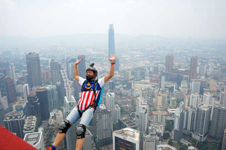 Kuala Lumpur, Malaysia â September 29, 2018: Base Jumpers jump from a 300m high deck during the Kuala Lumpur Tower International Jump.のeditorial素材