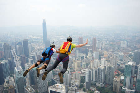 Kuala Lumpur, Malaysia â September 29, 2018: Base Jumpers jump from a 300m high deck during the Kuala Lumpur Tower International Jump.のeditorial素材
