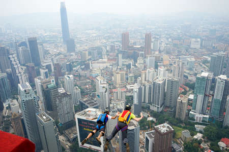 Kuala Lumpur, Malaysia â September 29, 2018: Base Jumpers jump from a 300m high deck during the Kuala Lumpur Tower International Jump.のeditorial素材