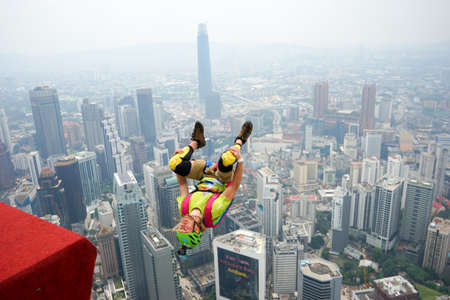 Kuala Lumpur, Malaysia â September 29, 2018: Base Jumpers jump from a 300m high deck during the Kuala Lumpur Tower International Jump.のeditorial素材