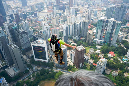 Kuala Lumpur, Malaysia â€“ September 29, 2018: Base Jumpers jump from a 300m high deck during...