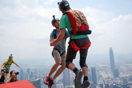Kuala Lumpur, Malaysia â€“ September 29, 2018: Base Jumpers jump from a 300m high deck during...
