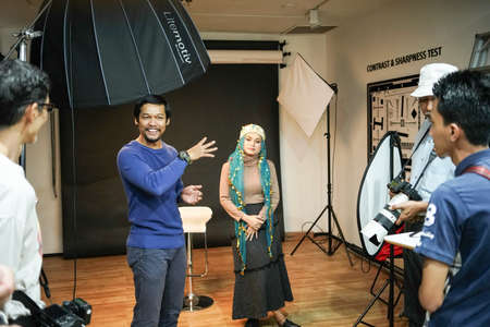 Kuala Lumpur, Malaysia â November 3, 2018: Group of photographers learning creative portrait during photo shooting in photography studio.のeditorial素材