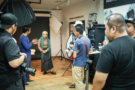 Kuala Lumpur, Malaysia â November 3, 2018: Group of photographers learning creative portrait during photo shooting in photography studio.のeditorial素材