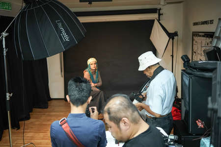Kuala Lumpur, Malaysia â November 3, 2018: Group of photographers learning creative portrait during photo shooting in photography studio.のeditorial素材