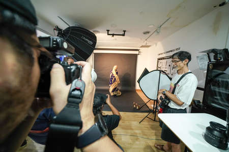 Kuala Lumpur, Malaysia â November 3, 2018: Group of photographers learning creative portrait during photo shooting in photography studio.のeditorial素材