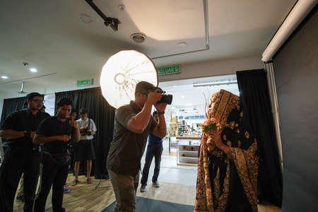 Kuala Lumpur, Malaysia â November 3, 2018: Group of photographers learning creative portrait during photo shooting in photography studio.のeditorial素材