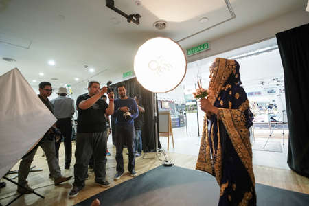Kuala Lumpur, Malaysia â November 3, 2018: Group of photographers learning creative portrait during photo shooting in photography studio.のeditorial素材