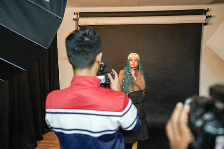 Kuala Lumpur, Malaysia â November 3, 2018: Group of photographers learning creative portrait during photo shooting in photography studio.のeditorial素材